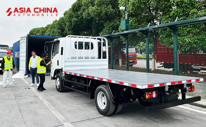 Ready for the Road: Isuzu KV100 Flatbed Trucks Loaded for Delivery to Moscow